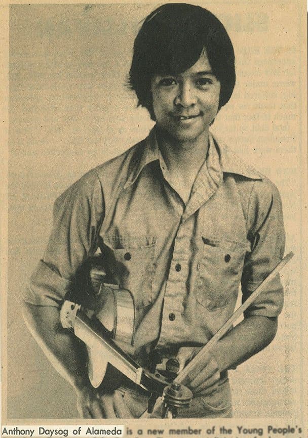 Newspaper photo of a teenaged Anthony Daysog holding a violin and bow. The caption begins: “Anthony Daysog of Alameda is a new member of the Young People’s…”